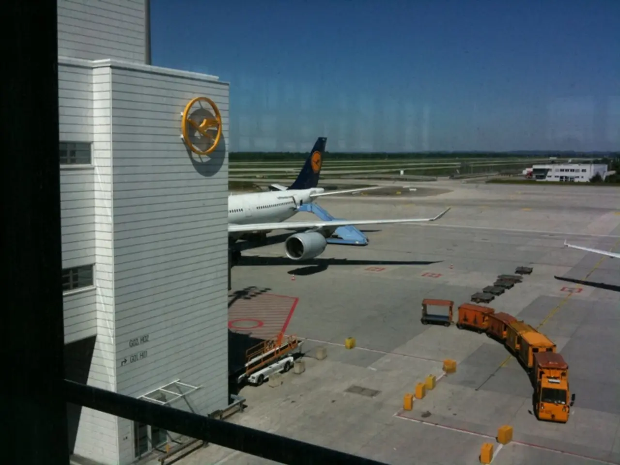 In this image there is an airplane on the road, having few vehicles and few objects are on the...