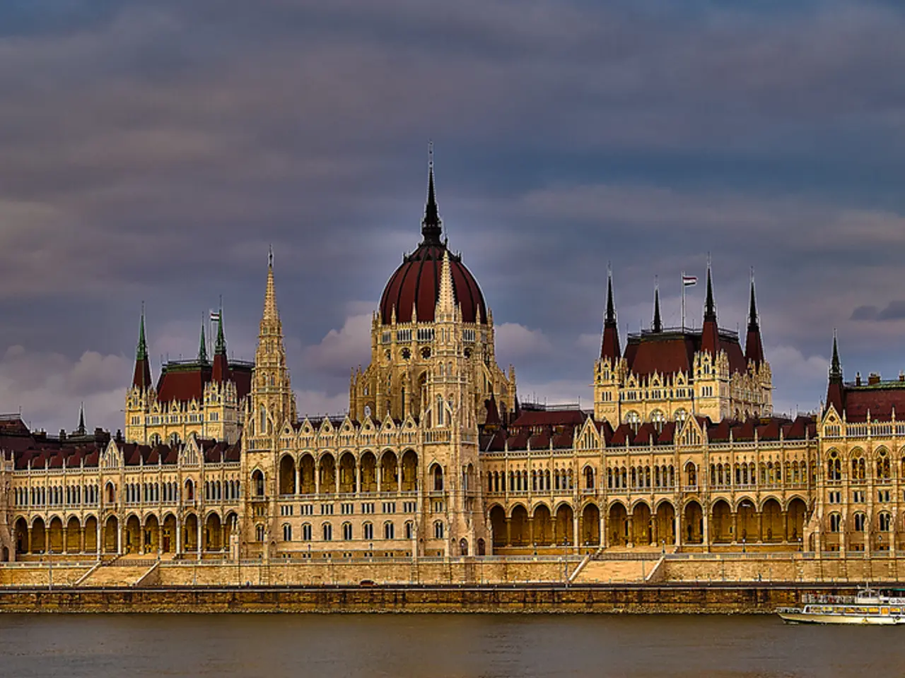 Sky is cloudy. Ship is floating on water. Buildings with windows. Beside this buildings there are...