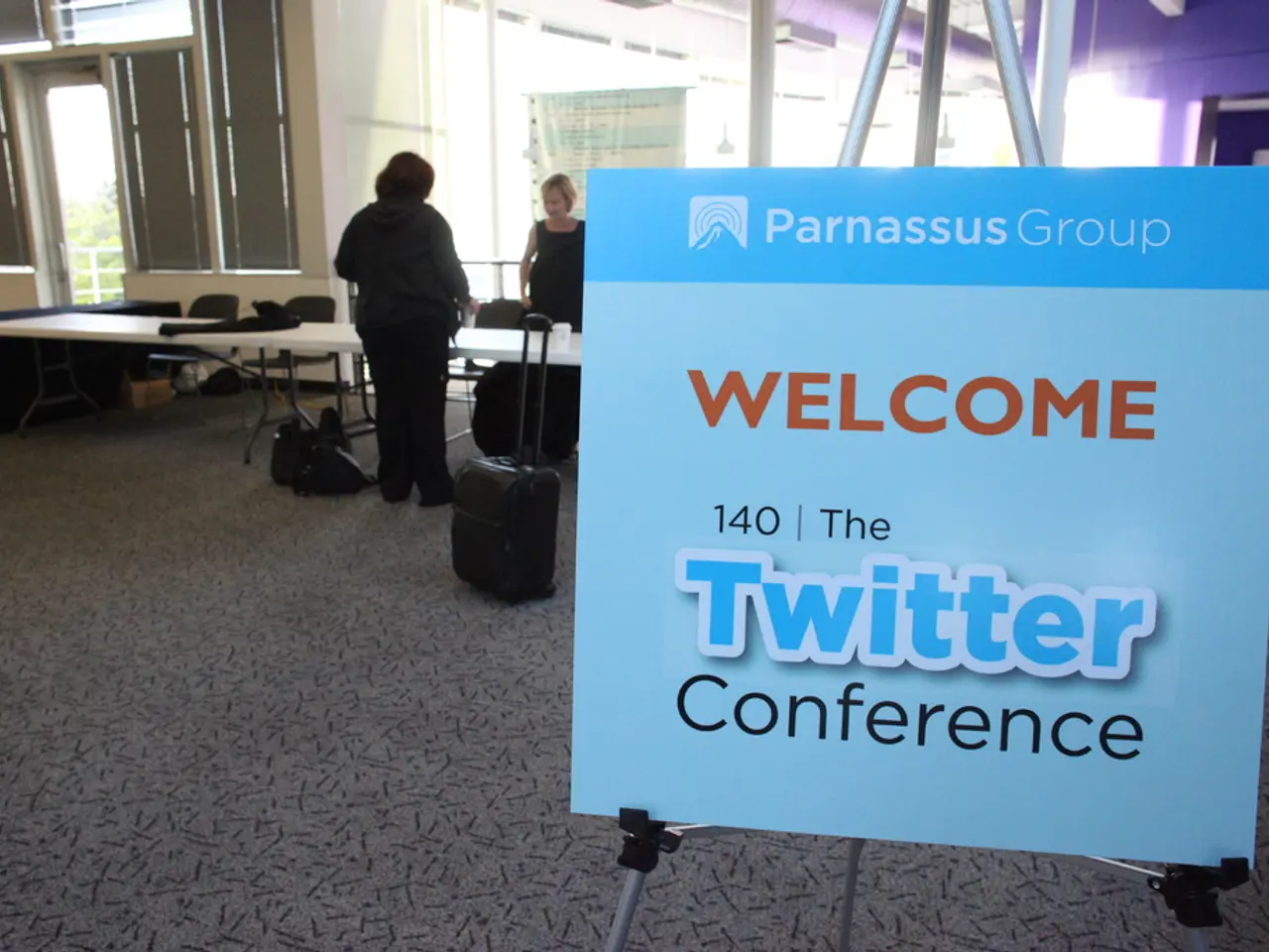 In this image I can see a board where welcome and twitter is written on it. In the background I can...