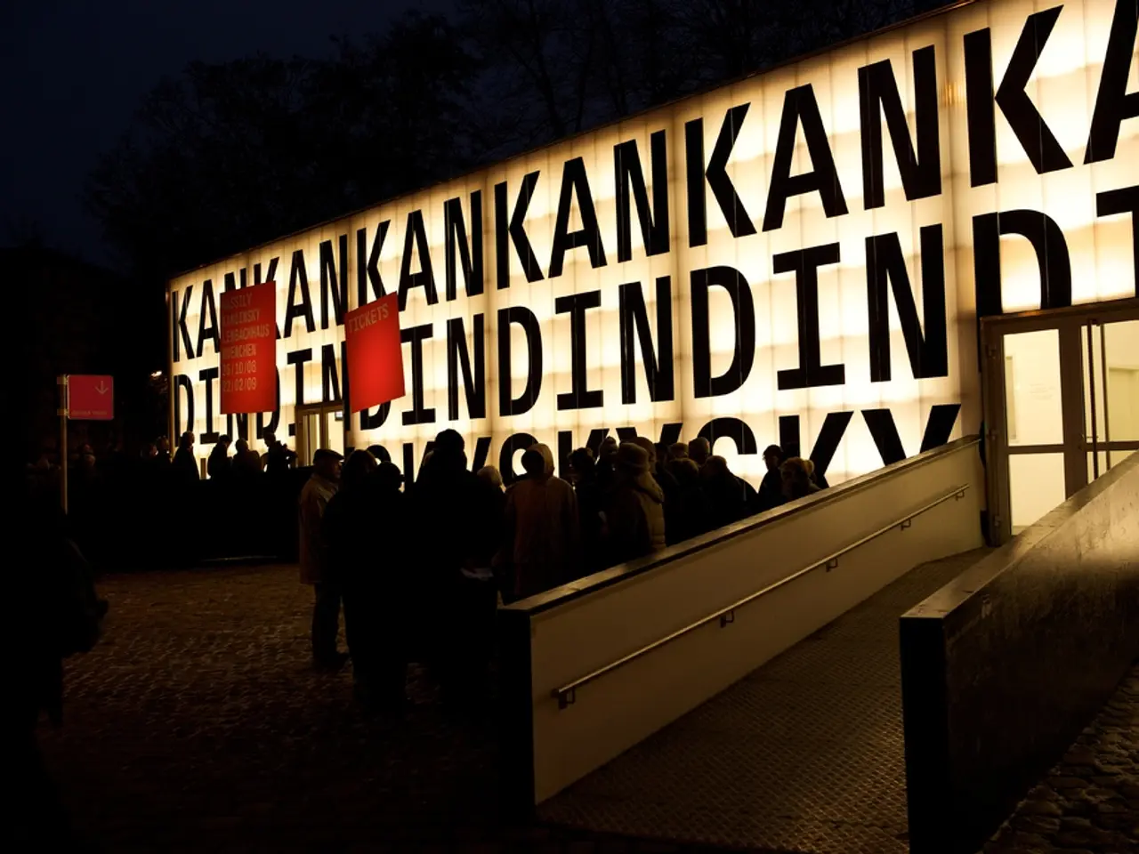 At the center of the image there are people standing in front of the building. There is a door,...