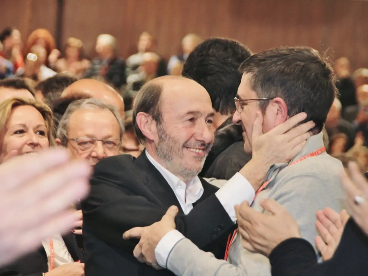 This image is inside of an auditorium, there are few people in the auditorium.