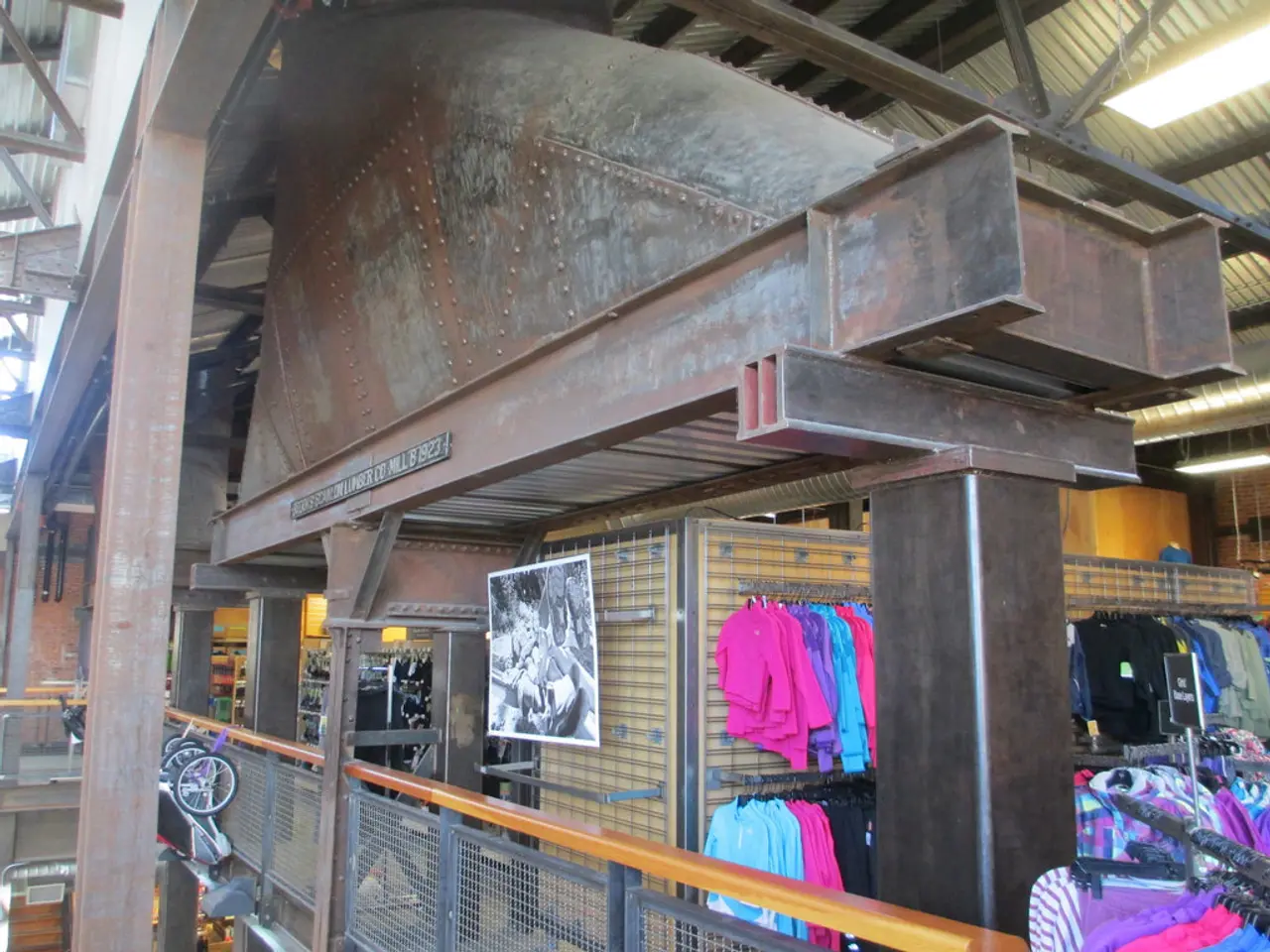 In this picture we can see few clothes, lights, metal rods and carts, and also we can find fence.