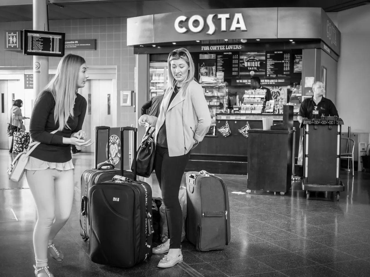 In the image there are two woman and in front of them there are luggage bags and back side there is...