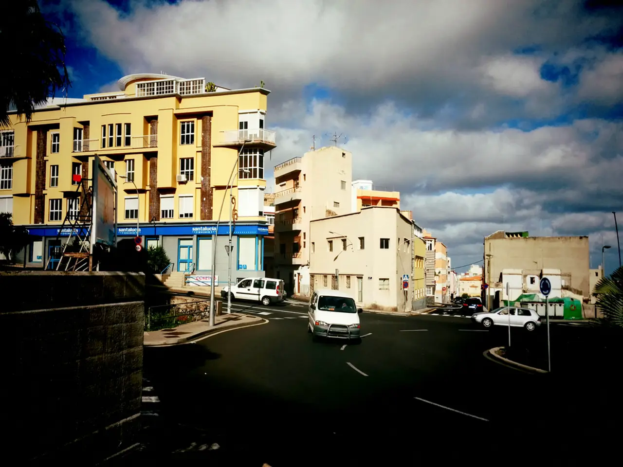 The picture is clicked on the street of a city. In the foreground of the picture there are...