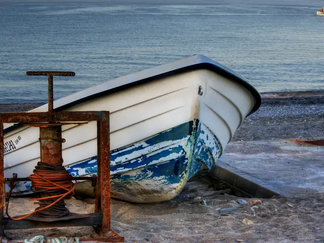 In this image I can see on the left side there is a metal thing. In the middle it is the boat on...