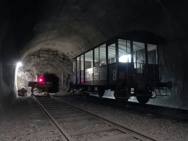 In this image we can see few railway tracks. There is a train carriage in the image. There are many...