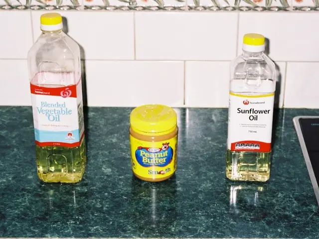 In this image there are three bottles placed on a table. Both the ends there are oil bottles but in...