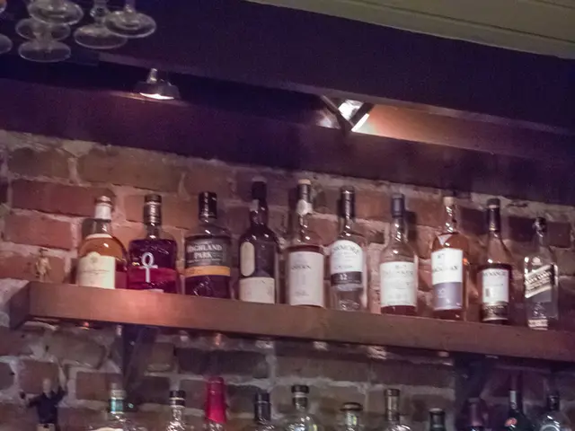 There are some wine bottles arranged in shelves.