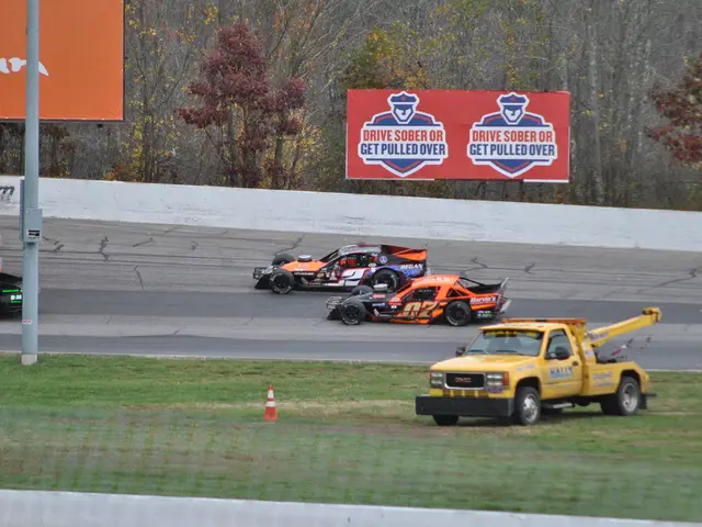 In this image in the center there are some vehicles, and at the bottom there is a walkway and...