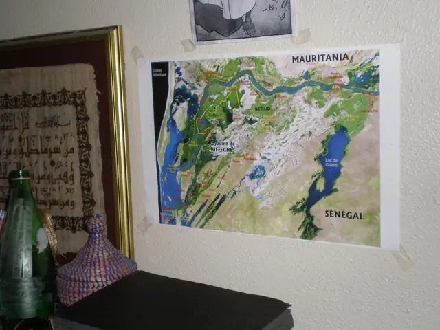 In this image we can see there are some posters and a frame attached to the wall, in front of the...