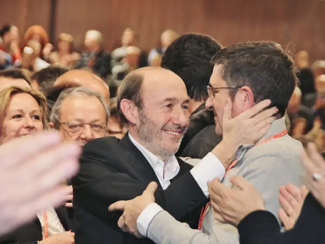 This image is inside of an auditorium, there are few people in the auditorium.