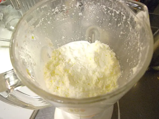 In this image we can see food in the food processor.